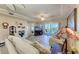Bright living room with modern ceiling fan and a water view from the balcony at 3322 Purple Martin Dr # 135, Punta Gorda, FL 33950