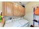 Bright laundry room with washer, dryer, and ample cabinetry at 3322 Purple Martin Dr # 135, Punta Gorda, FL 33950