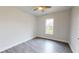 Simple bedroom with wood-look floors and window at 28968 Gin Ln, Punta Gorda, FL 33982