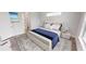 Bright bedroom with large bed, wood-look floors, and window at 28968 Gin Ln, Punta Gorda, FL 33982