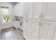 Laundry room with white cabinets and granite countertop at 28968 Gin Ln, Punta Gorda, FL 33982