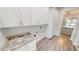 Laundry room with white cabinets and granite countertop at 28968 Gin Ln, Punta Gorda, FL 33982