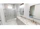 Modern bathroom with double vanity, marble tile, and shower at 28968 Gin Ln, Punta Gorda, FL 33982