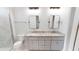 Bathroom with double vanity, granite countertop, and shower at 28968 Gin Ln, Punta Gorda, FL 33982