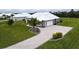 New construction home with paver driveway and landscaped lawn at 28968 Gin Ln, Punta Gorda, FL 33982