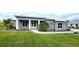 Gray house with white trim, metal roof, and landscaping at 28968 Gin Ln, Punta Gorda, FL 33982