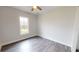 Simple bedroom with wood-look floors and window at 28968 Gin Ln, Punta Gorda, FL 33982