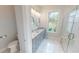 Elegant bathroom with double vanity, marble tile, and shower at 28968 Gin Ln, Punta Gorda, FL 33982