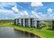 Aerial view showcasing condo building, golf course and lake at 14041 Heritage Landing Blvd # 615, Punta Gorda, FL 33955