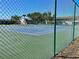 View of community tennis courts through the chain link fence on a bright sunny day at 9209 Seminole Blvd # 117, Seminole, FL 33772