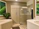 Spa-like bathroom featuring a soaking tub, walk-in shower, and calming nature mural at 98 Vivante Blvd # 98412, Punta Gorda, FL 33950