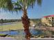 Scenic condo community view with palm trees, water features, and resort-style buildings at 98 Vivante Blvd # 98412, Punta Gorda, FL 33950