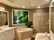 Elegant bathroom with double sinks, a large soaking tub, and a walk-in shower at 98 Vivante Blvd # 98412, Punta Gorda, FL 33950