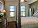 Spacious main bedroom with a post bed, dresser, and plenty of natural light at 98 Vivante Blvd # 98412, Punta Gorda, FL 33950