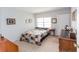 Comfortable bedroom with a patchwork quilt and wood furniture at 9209 Seminole Blvd # 117, Seminole, FL 33772