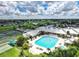 Stunning aerial view showcasing the community pool, clubhouse, and well-maintained grounds at 1712 Lastingham Ln, Port Charlotte, FL 33980