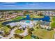 Beautiful aerial view of community, highlighting the pool, clubhouse, golf course and scenic lakes at 1712 Lastingham Ln, Port Charlotte, FL 33980