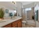 Bright bathroom featuring a combination tub and shower, vanity with drawers, and decorative accents at 1712 Lastingham Ln, Port Charlotte, FL 33980