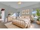 Charming bedroom features a ceiling fan, art and decor, a comfy bed and a window to the outside at 1712 Lastingham Ln, Port Charlotte, FL 33980