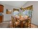 Dining area featuring a chandelier, a wooden table with seating for six, and natural light from large windows at 1712 Lastingham Ln, Port Charlotte, FL 33980