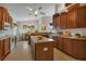 Open kitchen with an island, ample wood cabinetry, stainless steel appliances, and an adjacent breakfast nook at 1712 Lastingham Ln, Port Charlotte, FL 33980