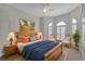 Spacious bedroom with shuttered windows, decor, area rug, ceiling fan, and nightstands on either side of bed at 1712 Lastingham Ln, Port Charlotte, FL 33980