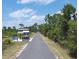 Paved road leads to a park with a kiosk at 1871 Mossy Oak Dr, North Port, FL 34287