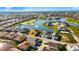 Aerial view of community, showcasing houses, golf course, and lake at 1712 Lastingham Ln, Port Charlotte, FL 33980