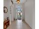 Bright and spacious entryway with tile floors and an open door at 1712 Lastingham Ln, Port Charlotte, FL 33980