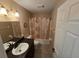 Bathroom featuring vanity, toilet, mirror and tub with shower curtain at 21427 Michigan Ave, Port Charlotte, FL 33952