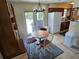 View of the dining area with wood table and chairs, access to back yard and open view to the kitchen at 21427 Michigan Ave, Port Charlotte, FL 33952