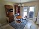 Cozy dining area with wood table, three chairs, built-in hutch, and a view of the exterior at 21427 Michigan Ave, Port Charlotte, FL 33952