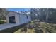Detached storage shed with a roll-up door in backyard at 21427 Michigan Ave, Port Charlotte, FL 33952