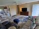View of the living room, showing seating area, television, entry door and access to the kitchen at 21427 Michigan Ave, Port Charlotte, FL 33952