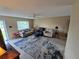 Spacious living room featuring neutral walls, comfortable seating and a patterned area rug at 21427 Michigan Ave, Port Charlotte, FL 33952