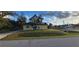 Cute yellow house with solar panels and a well-maintained lawn at 21427 Michigan Ave, Port Charlotte, FL 33952