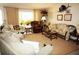 Bright living room featuring comfy seating, large windows, and a decorative fish mount at 21277 Edgewater Dr, Port Charlotte, FL 33952