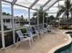 Screened pool area with water view and seating at 21277 Edgewater Dr, Port Charlotte, FL 33952