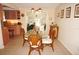 Charming dining room featuring a glass table and wicker chairs, with a view to kitchen and living room at 21277 Edgewater Dr, Port Charlotte, FL 33952