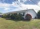 Side view of a white house with landscaping at 21277 Edgewater Dr, Port Charlotte, FL 33952