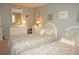 Bedroom with twin beds, white dresser, and coastal decor at 21277 Edgewater Dr, Port Charlotte, FL 33952