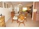 Bright dining room with a glass-top table and wicker chairs, adjacent to kitchen and living room at 21277 Edgewater Dr, Port Charlotte, FL 33952