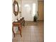 Bright entryway with tile floors and wicker console table at 21277 Edgewater Dr, Port Charlotte, FL 33952