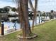 Serene waterfront view with dock and palm trees at 21277 Edgewater Dr, Port Charlotte, FL 33952