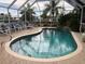 Inviting screened pool with lounge chairs at 21277 Edgewater Dr, Port Charlotte, FL 33952