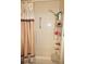 Bathroom with shower, beige walls and seashell shower curtain at 21277 Edgewater Dr, Port Charlotte, FL 33952