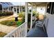 Covered porch with white railings and striped chairs at 21277 Edgewater Dr, Port Charlotte, FL 33952