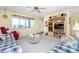 Bright living room featuring comfy seating and a classic entertainment center at 22375 Edgewater Dr # 239, Port Charlotte, FL 33980