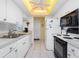 Well-equipped kitchen with white cabinetry and modern appliances at 22375 Edgewater Dr # 239, Port Charlotte, FL 33980