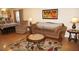 Living area featuring a sofa, recliner, and a view into the dining area at 175 Kings Hwy # 411, Punta Gorda, FL 33983